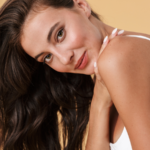 Young brunette woman with natural-looking skin featured in a sculptra pros and cons educational blog