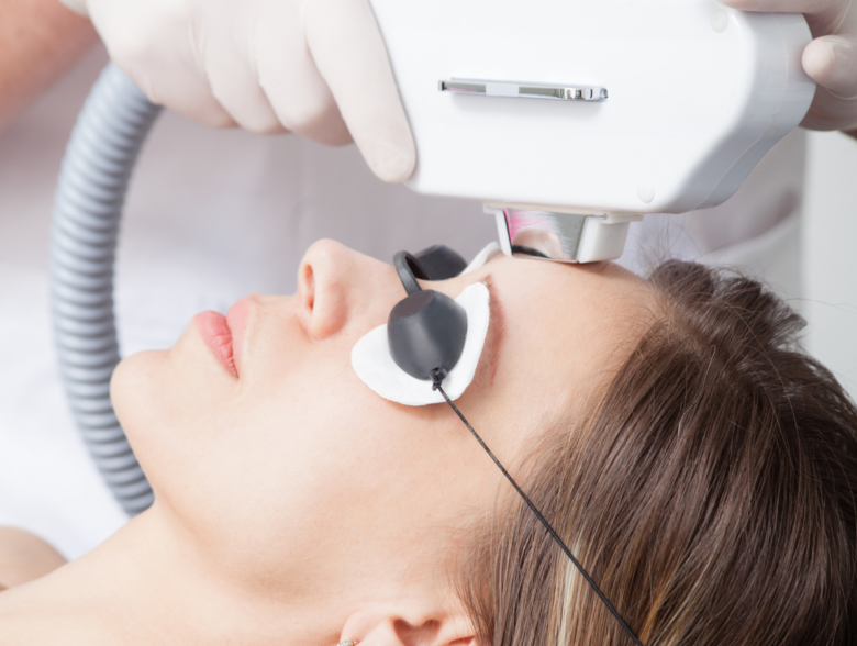 Woman receiving an IPL laser facial treatment during a benefits of IPL laser skincare session