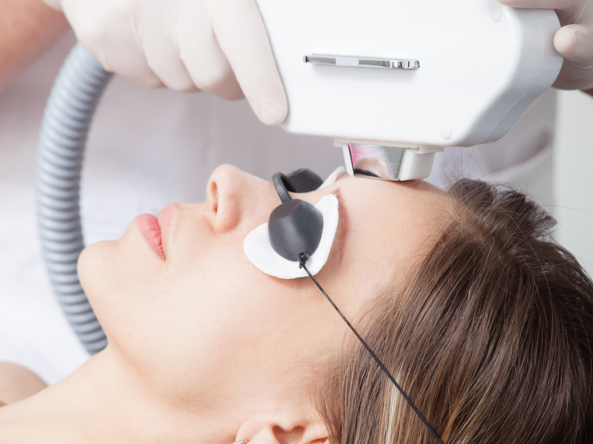 Woman receiving an IPL laser facial treatment during a benefits of IPL laser skincare session