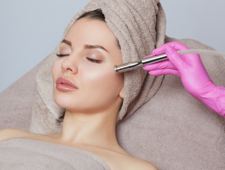 Woman receiving a professional microdermabrasion treatment during a microdermabrasion vs dermaplaning skincare consultation