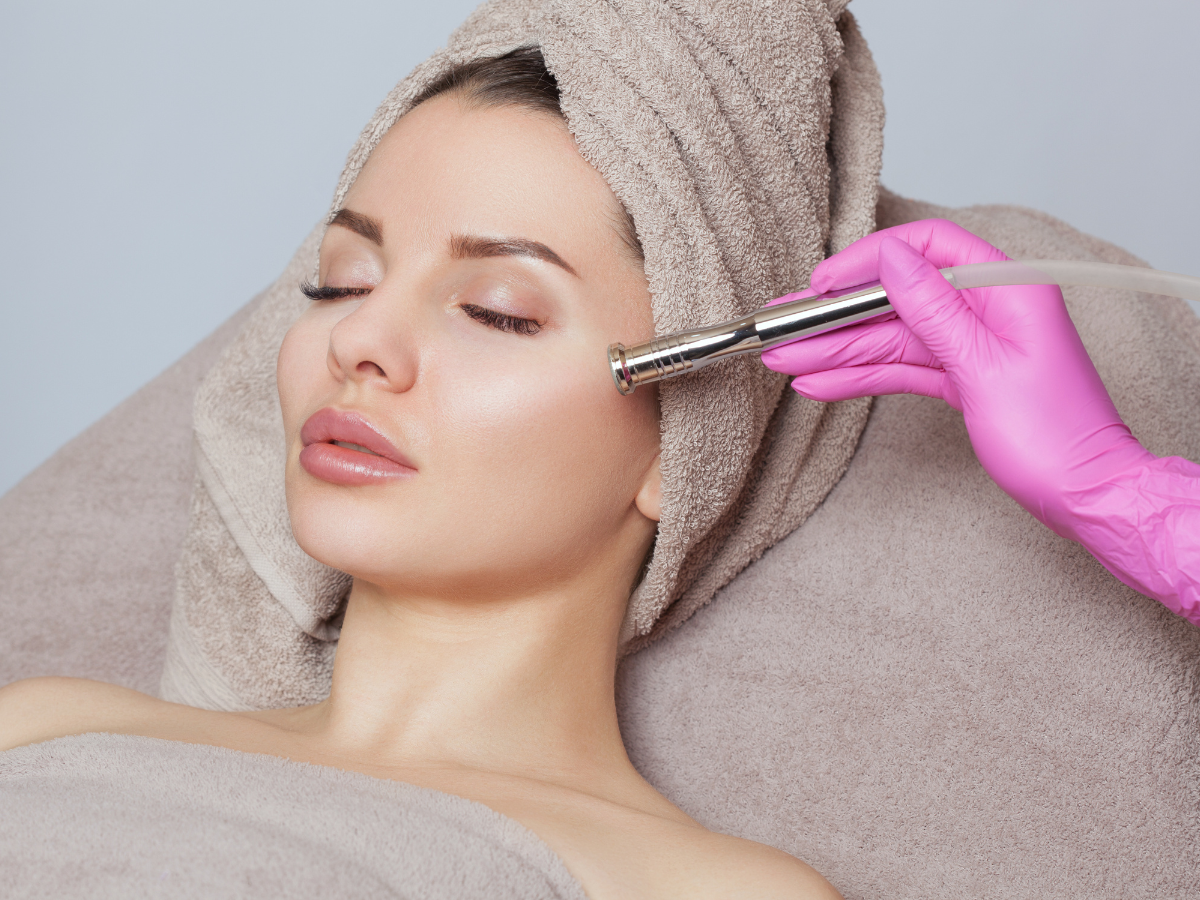 Woman receiving a professional microdermabrasion treatment during a microdermabrasion vs dermaplaning skincare consultation