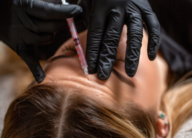 Woman receiving forehead Botox injections during Sculptra vs Botox injectable facial rejuvenation treatment consultation