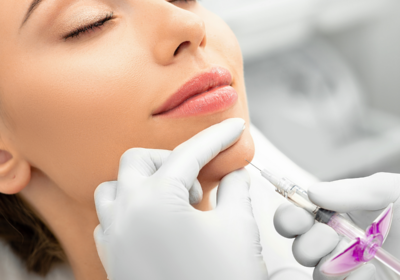 Patient receiving chin and jawline dermal filler treatment illustrating best jawline filler options for facial contouring
