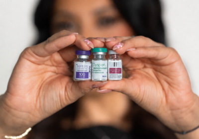 Injector comparing Dysport and Botox wrinkle relaxer vials at a San Antonio med spa